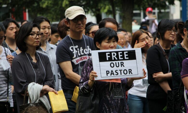 woman with sign 1.jpg.size .custom.crop .1086x724
