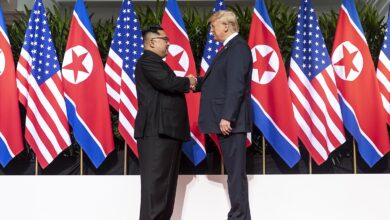 Important US-North Korea Meeting Postponed – Why? 2 1200px Kim and Trump shaking hands at the red carpet during the DPRK–USA Singapore Summit